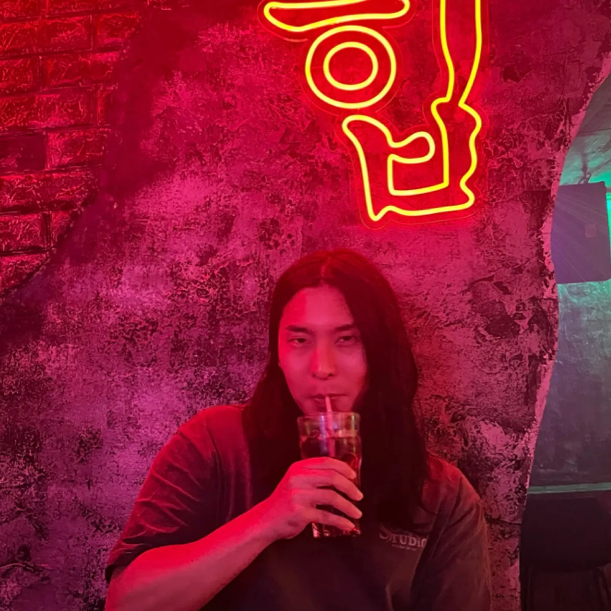 Red neon portrait of Marcus Ka, solo founder behind Madman Studio